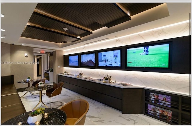 interior space featuring marble finish floor and a raised ceiling