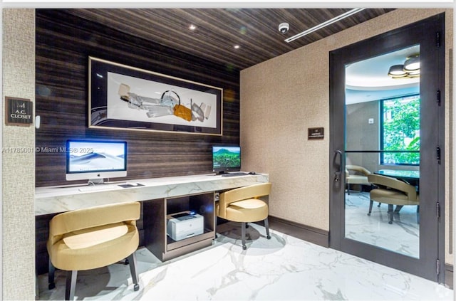 home office featuring wooden walls, baseboards, marble finish floor, and wooden ceiling