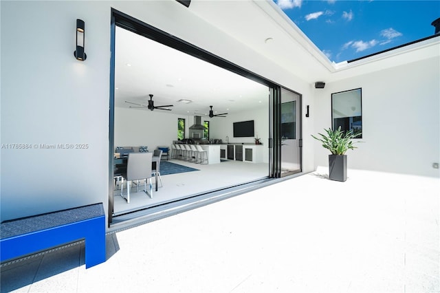view of patio / terrace featuring a ceiling fan and exterior kitchen