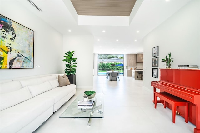 living room featuring baseboards and recessed lighting