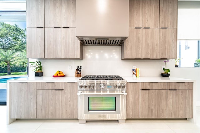 kitchen featuring light countertops, stainless steel stove, and modern cabinets