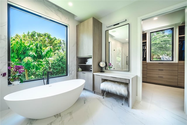 full bath featuring walk in shower, a healthy amount of sunlight, and a freestanding tub
