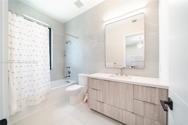 full bath featuring shower / bath combination with curtain, visible vents, toilet, vanity, and tile walls