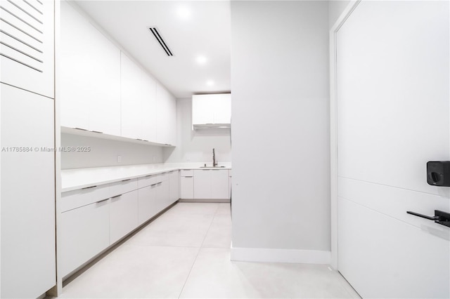 kitchen featuring light tile patterned flooring, light countertops, white cabinetry, visible vents, and recessed lighting