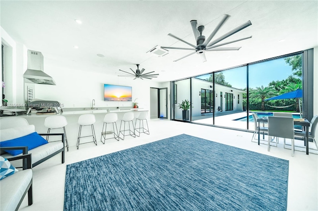 view of patio featuring an outdoor pool, a bar, visible vents, a sink, and ceiling fan