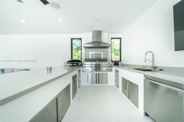 kitchen featuring a sink, fridge, a wealth of natural light, light countertops, and wall chimney exhaust hood