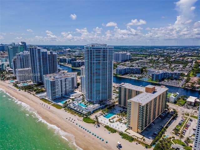 bird's eye view featuring a view of the beach, a city view, and a water view