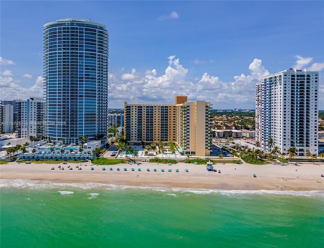 drone / aerial view featuring a beach view and a water view