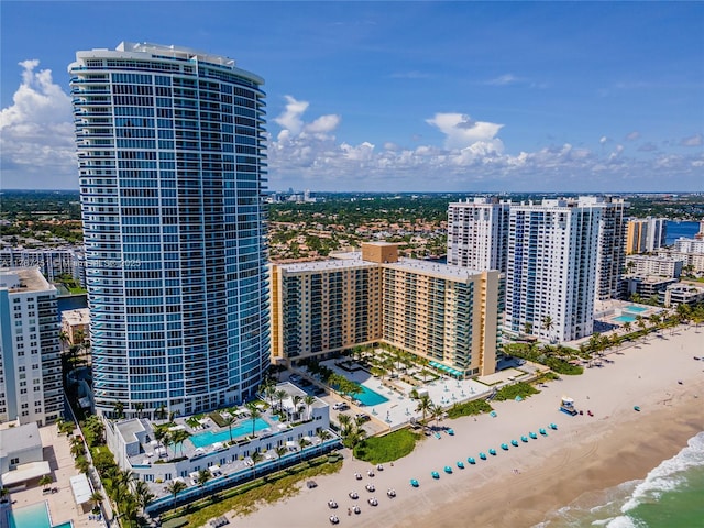 aerial view featuring a beach view, a water view, and a city view