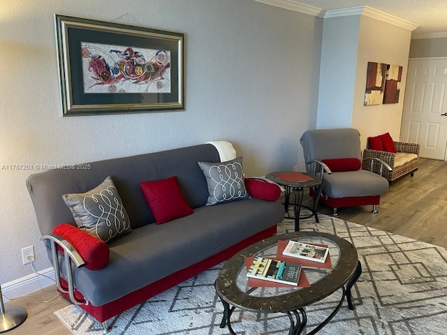 living room with wood finished floors, crown molding, a textured wall, and baseboards