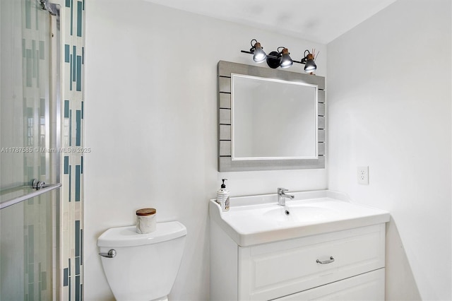 full bathroom with a shower stall, toilet, and vanity