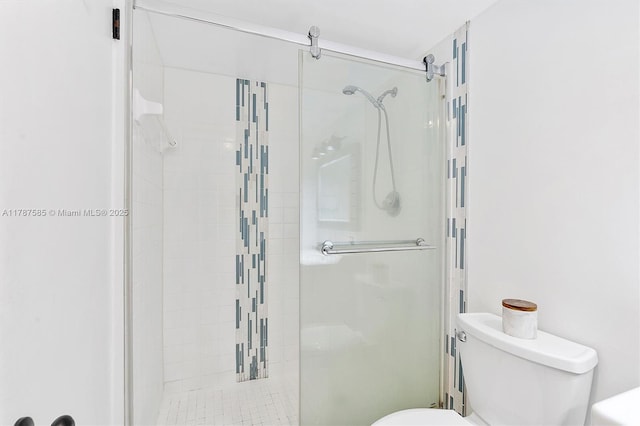 bathroom with a stall shower and toilet