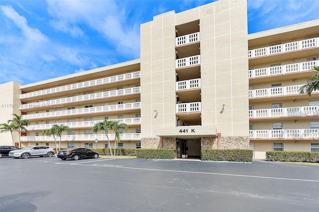 view of building exterior with uncovered parking