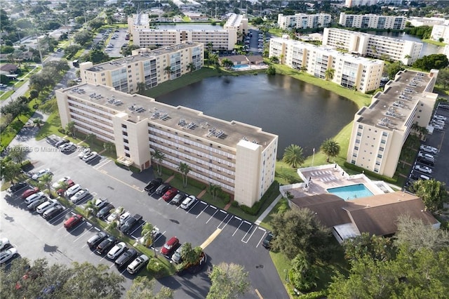 birds eye view of property featuring a city view and a water view