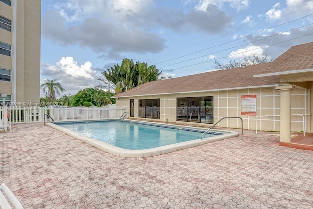 community pool featuring a patio area and fence
