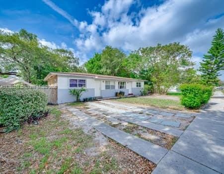 single story home featuring fence