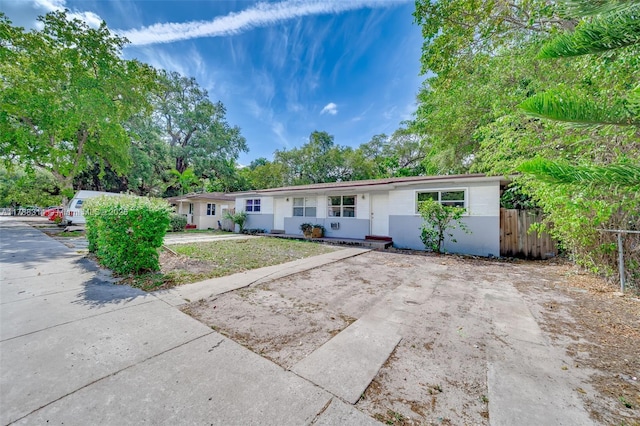 ranch-style home featuring fence