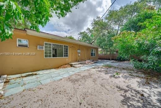 back of house with stucco siding, a patio area, and fence