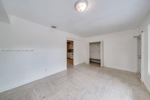 unfurnished bedroom featuring visible vents and a closet
