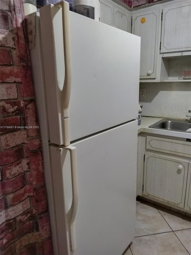 6510 Winfield Blvd Unit 103, Margate, FL 33063 - kitchen featuring freestanding refrigerator, light countertops, and light tile patterned floors
