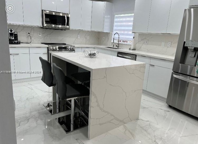111 NW 108th Ave, Pembroke Pines, FL 33026 - kitchen with white cabinets, appliances with stainless steel finishes, decorative backsplash, and a sink