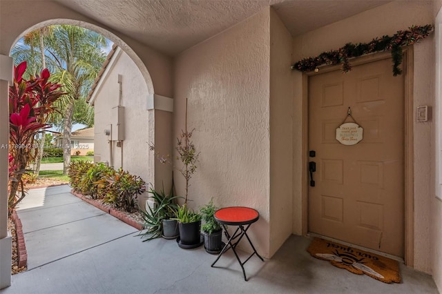 ranch-style home with stucco siding, driveway, a tiled roof, and an attached garage