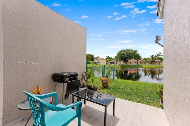 view of patio / terrace featuring a water view and a grill