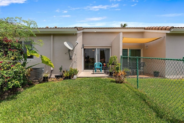 rear view of property featuring stucco siding and central AC unit