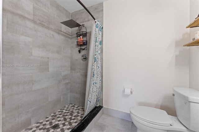 bathroom with toilet and a stall shower