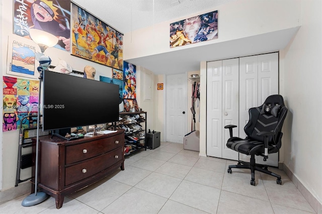 sitting room featuring light tile patterned floors and baseboards