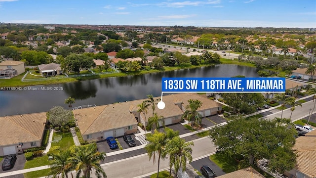 aerial view of property's location with nearby suburban area and a large body of water