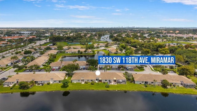 view of property location with a nearby body of water and nearby suburban area