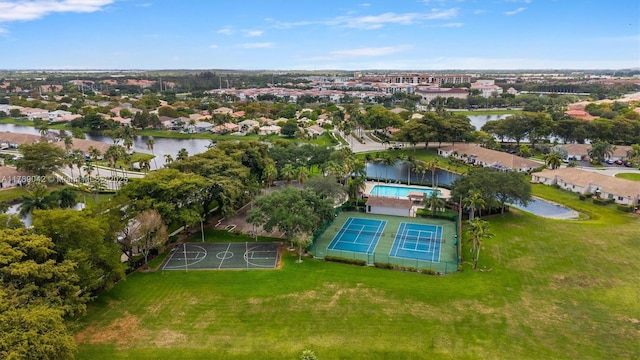 aerial view of residential area featuring a pool area and a nearby body of water