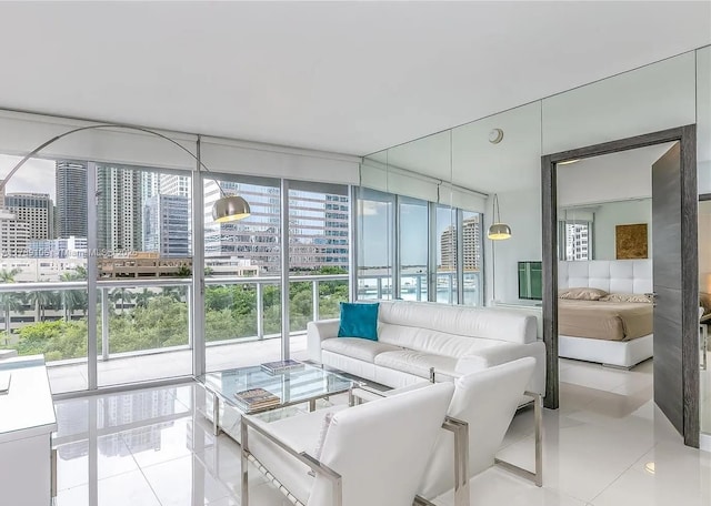 living area featuring floor to ceiling windows, tile patterned flooring, and a view of city