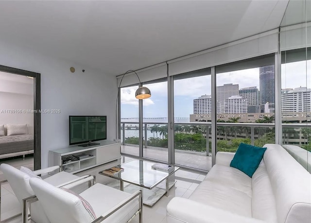 living room featuring expansive windows and tile patterned floors