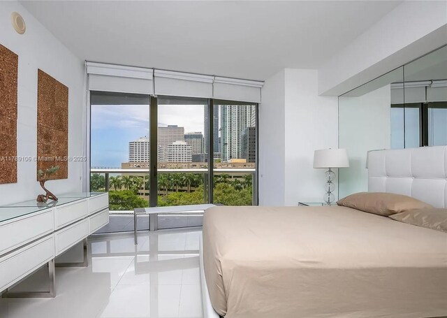 tiled bedroom featuring a view of city