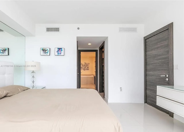 bedroom with visible vents and connected bathroom