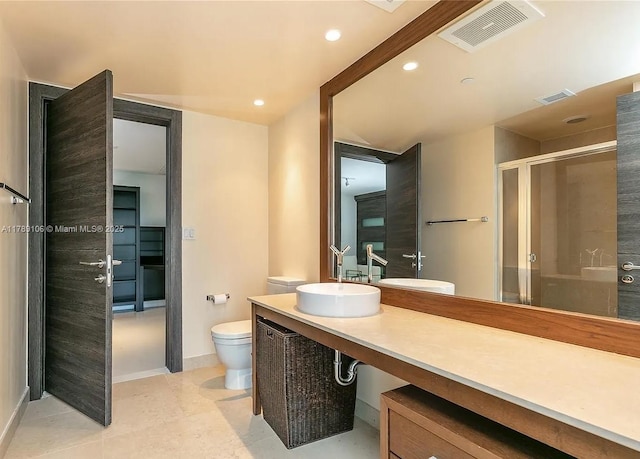 full bath featuring a shower stall, vanity, baseboards, toilet, and visible vents