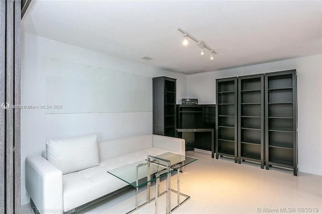 living room featuring track lighting and visible vents