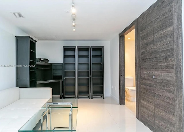 unfurnished living room featuring visible vents, tile patterned flooring, and baseboards