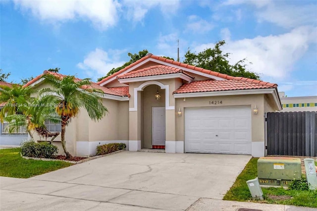 14214 SW 177th Ter, Miami, FL 33177 - mediterranean / spanish-style house featuring an attached garage, a tile roof, fence, and stucco siding