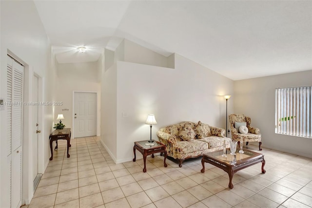 14214 SW 177th Ter, Miami, FL 33177 - living room featuring baseboards, vaulted ceiling, and light tile patterned floors
