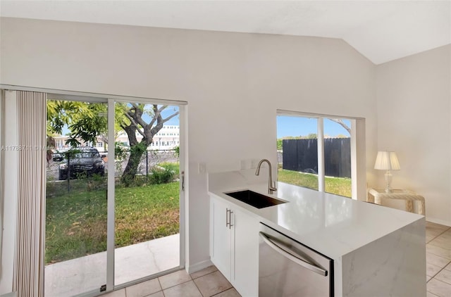 14214 SW 177th Ter, Miami, FL 33177 - kitchen with a peninsula, light tile patterned floors, stainless steel dishwasher, and a sink