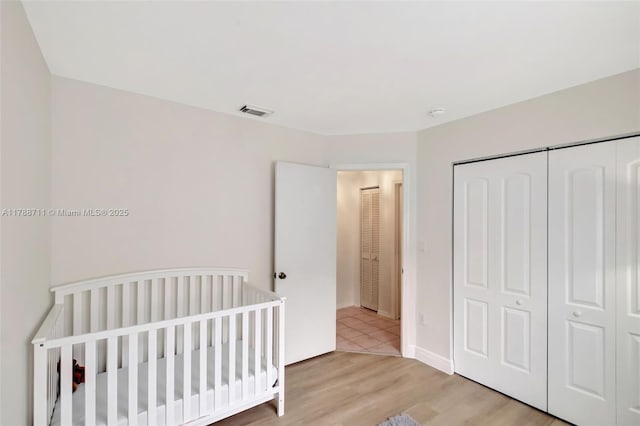 14214 SW 177th Ter, Miami, FL 33177 - bedroom featuring light wood-type flooring, a closet, and visible vents