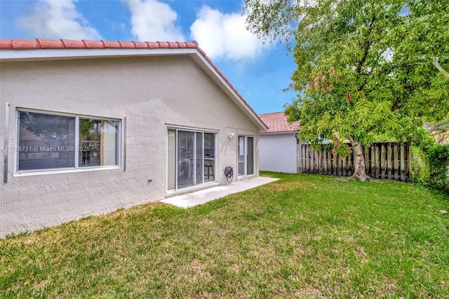 14214 SW 177th Ter, Miami, FL 33177 - rear view of house with fence, a lawn, a tile roof, and stucco siding