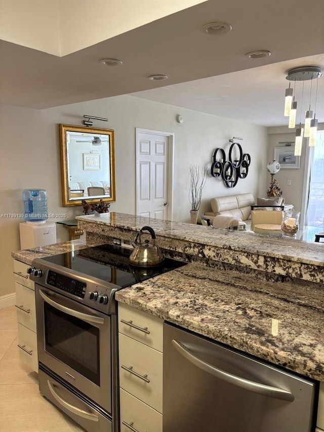 500 Three Islands Blvd Unit 313, Hallandale Beach, FL 33009 - kitchen with stainless steel appliances, light stone counters, open floor plan, and white cabinetry