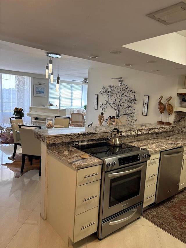 500 Three Islands Blvd Unit 313, Hallandale Beach, FL 33009 - kitchen with stainless steel appliances, light tile patterned flooring, light stone countertops, and white cabinetry