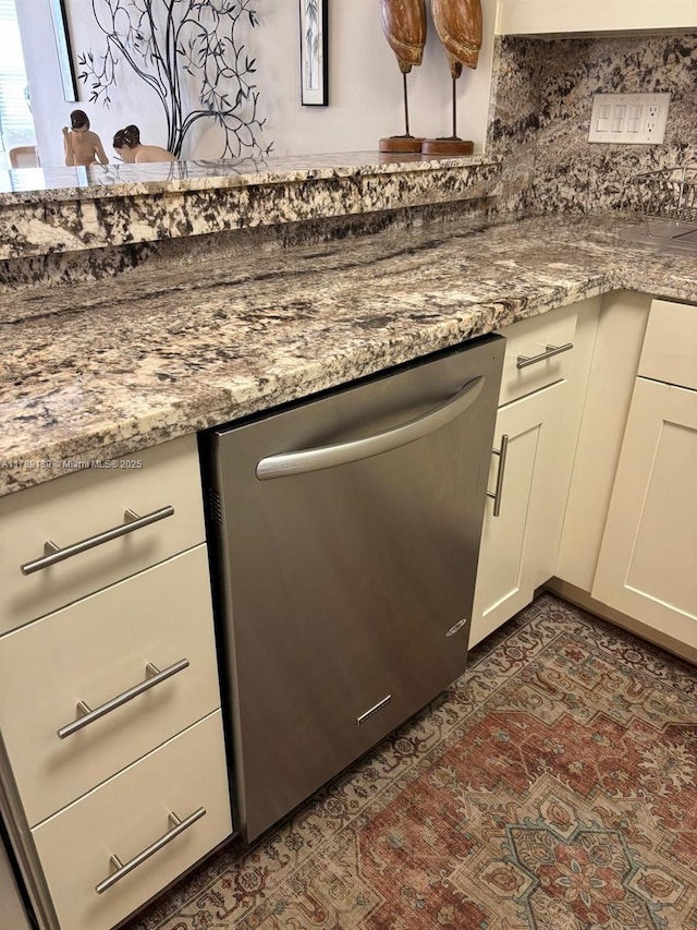 500 Three Islands Blvd Unit 313, Hallandale Beach, FL 33009 - kitchen view of stainless steel dishwasher, light stone counters, and white cabinetry