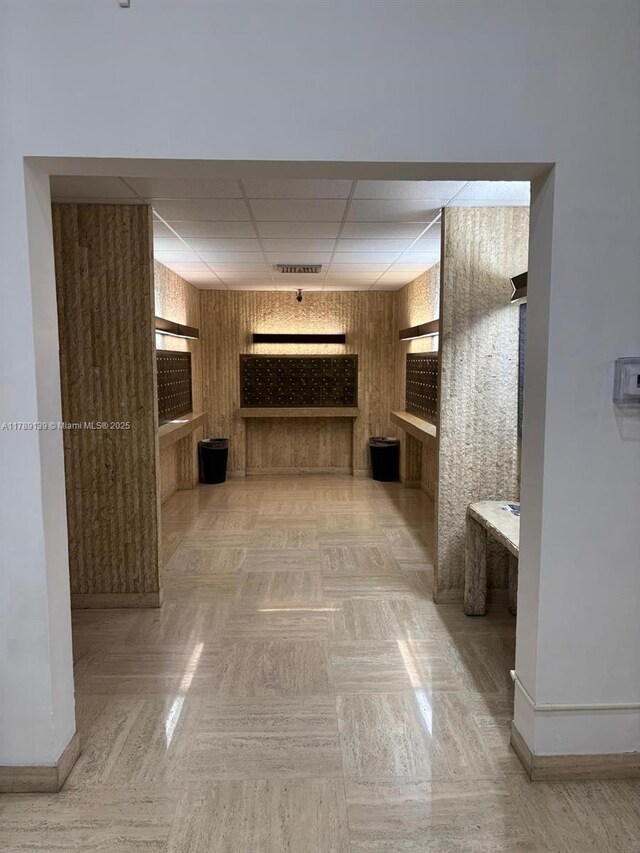500 Three Islands Blvd Unit 313, Hallandale Beach, FL 33009 - corridor featuring a paneled ceiling and baseboards