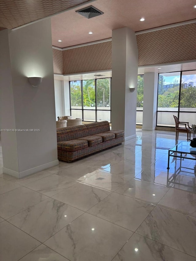 500 Three Islands Blvd Unit 313, Hallandale Beach, FL 33009 - living area with a towering ceiling, baseboards, marble tiled flooring, and recessed lighting